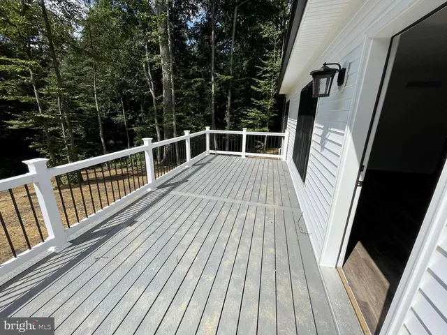 a view of balcony with wooden floor and fence