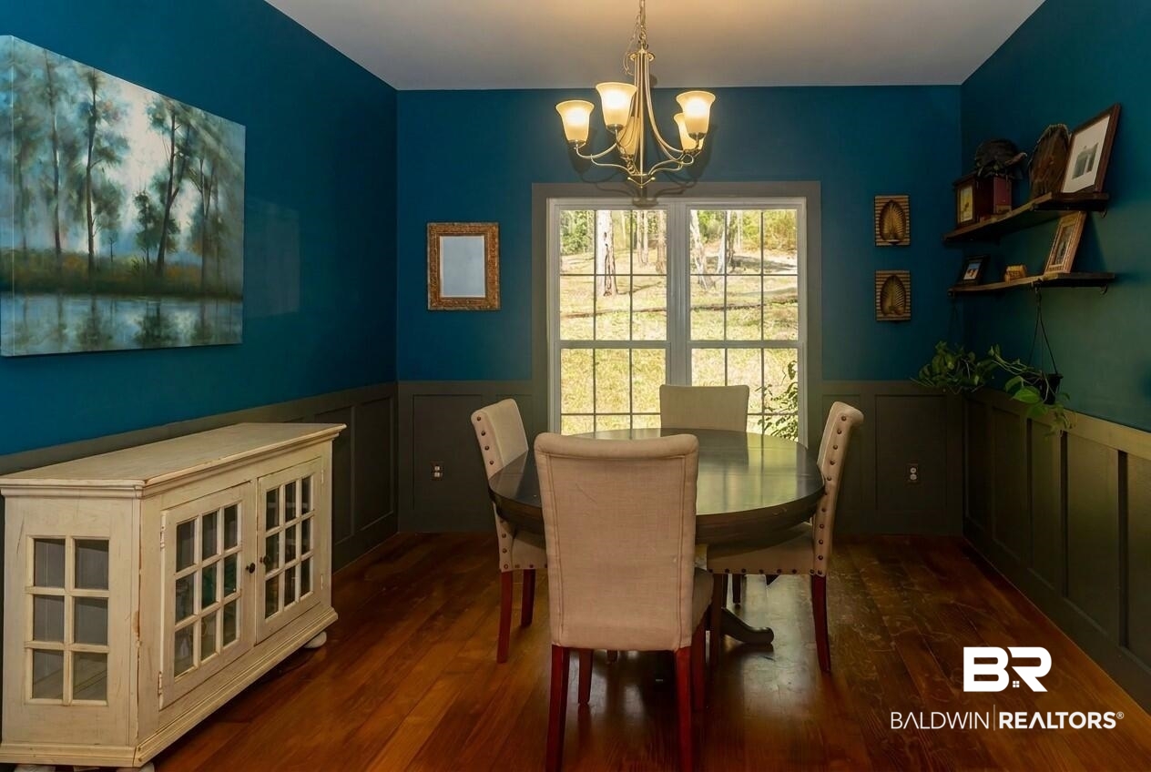 8008 Patricks Landing Road Bay Minette, AL 36507 - Photo 7 of 33 Dining area featuring rich wood-finish flooring, a multi-pane window, and a decorative chandelier