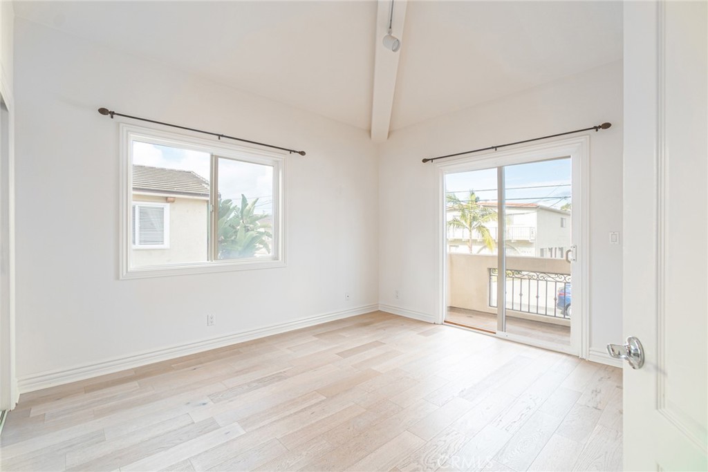 2216 Clark Lane, Unit A Redondo Beach, CA 90278 - Photo 18 of 20 an empty room with wooden floor and windows