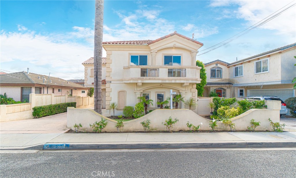 2216 Clark Lane, Unit A Redondo Beach, CA 90278 - Photo 2 of 20 a front view of a house with a yard and potted plants