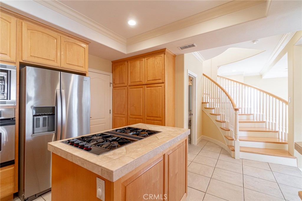 2216 Clark Lane, Unit A Redondo Beach, CA 90278 - Photo 7 of 20 a kitchen with granite countertop a refrigerator stove and cabinets