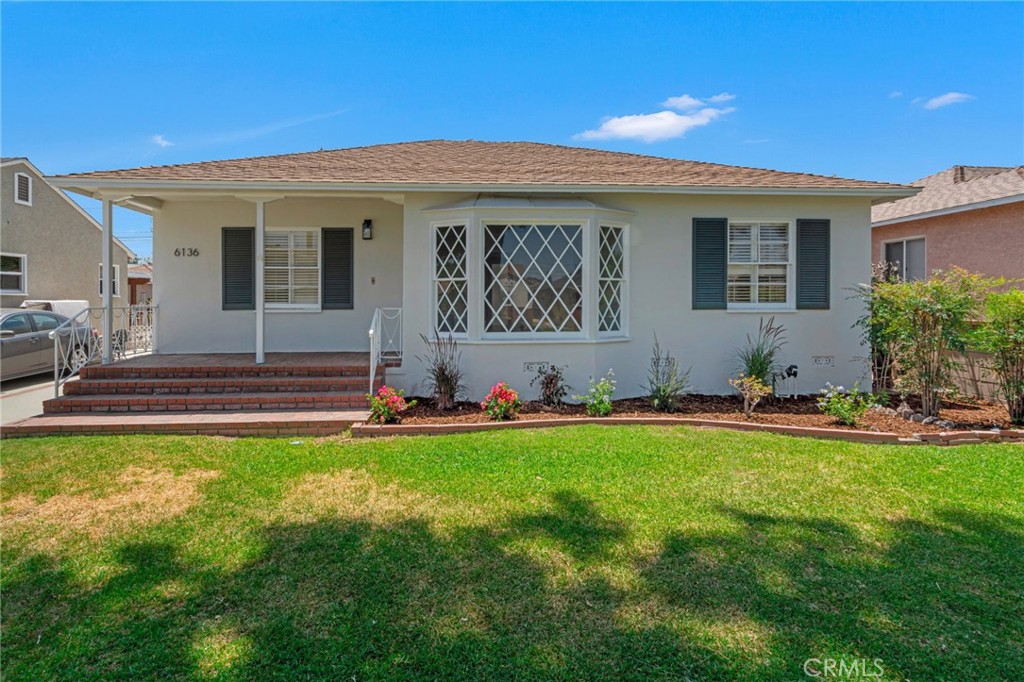 6136 Greenmeadow Road Lakewood, CA 90713 - Photo 1 of 1 a view of a house with a swimming pool and a yard