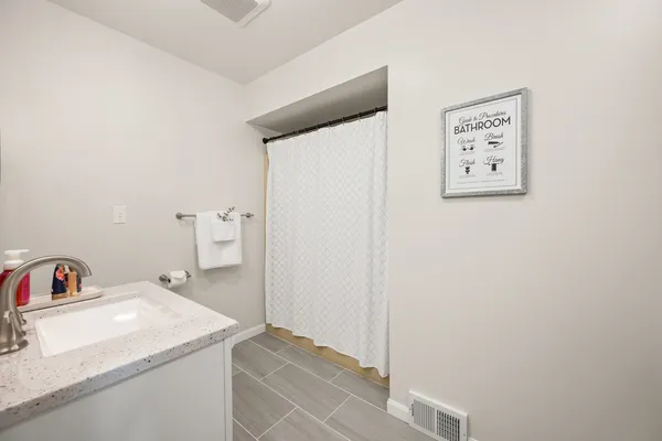 a view of a room with water heater and wooden floor