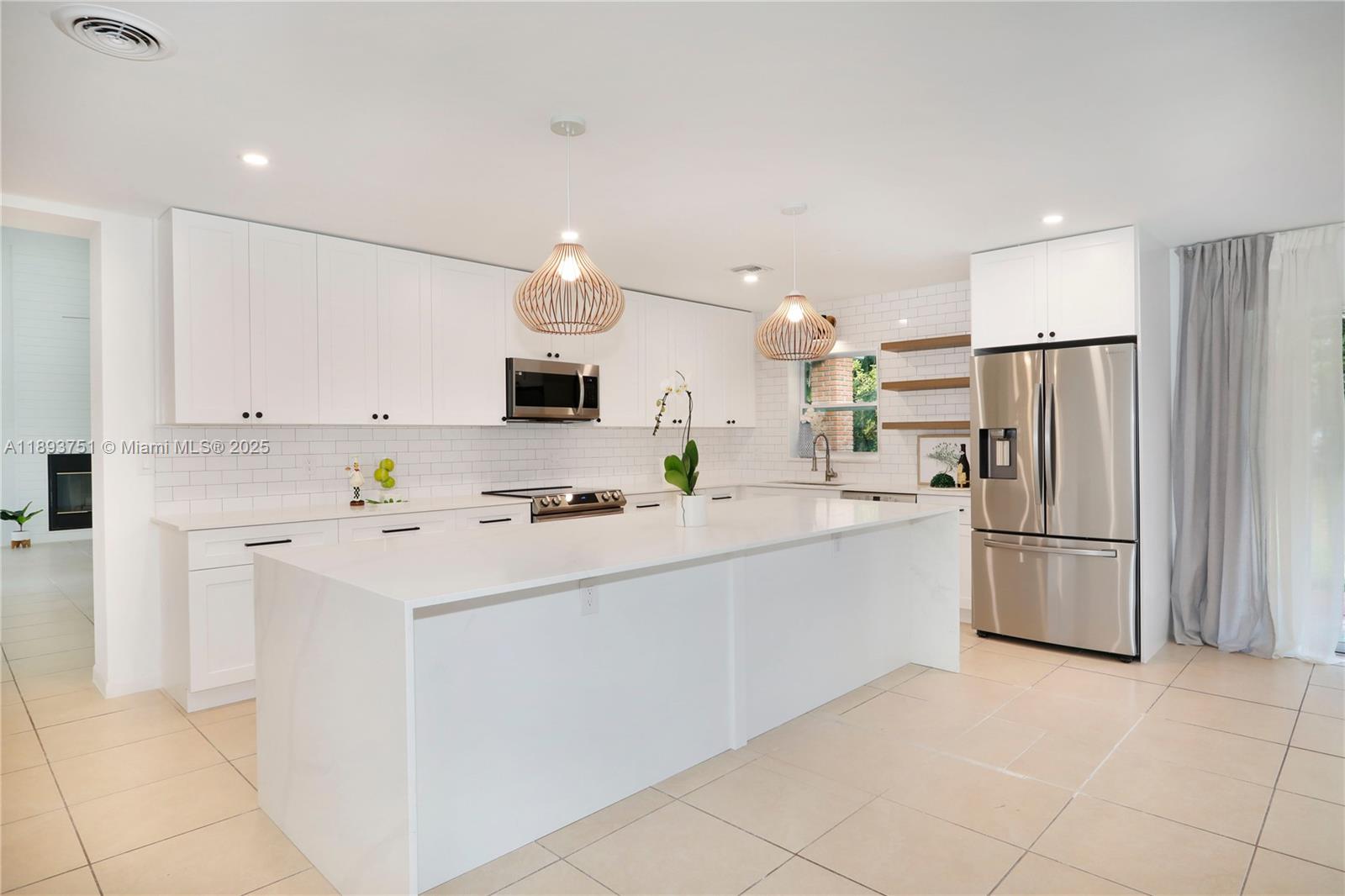 a kitchen with white cabinets and white appliances