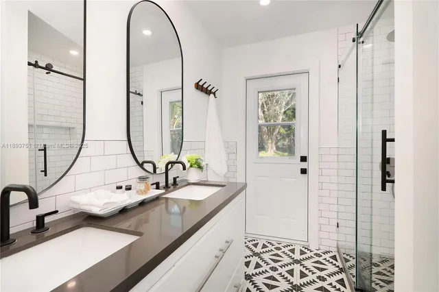 a bathroom with a double vanity sink and a mirror