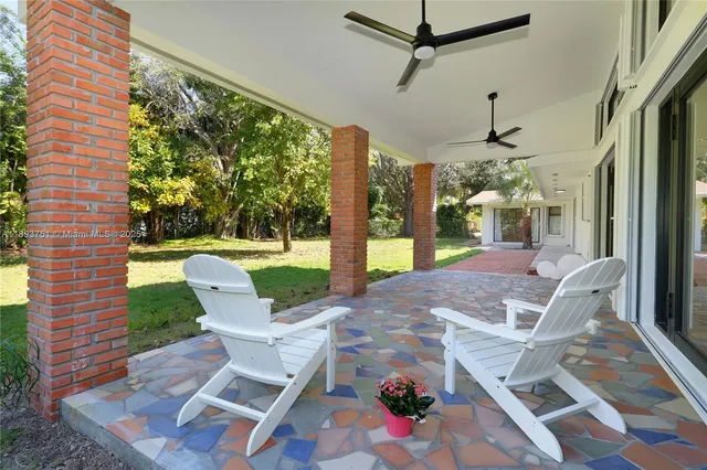 a view of a patio with a table chairs and backyard