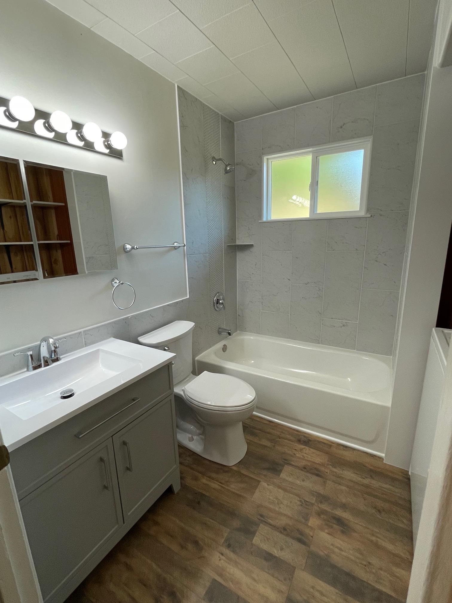 18191 Woodham Carne Road Sonora, CA 95370 - Photo 2 of 47 a bathroom with a double vanity sink a toilet a mirror and shower
