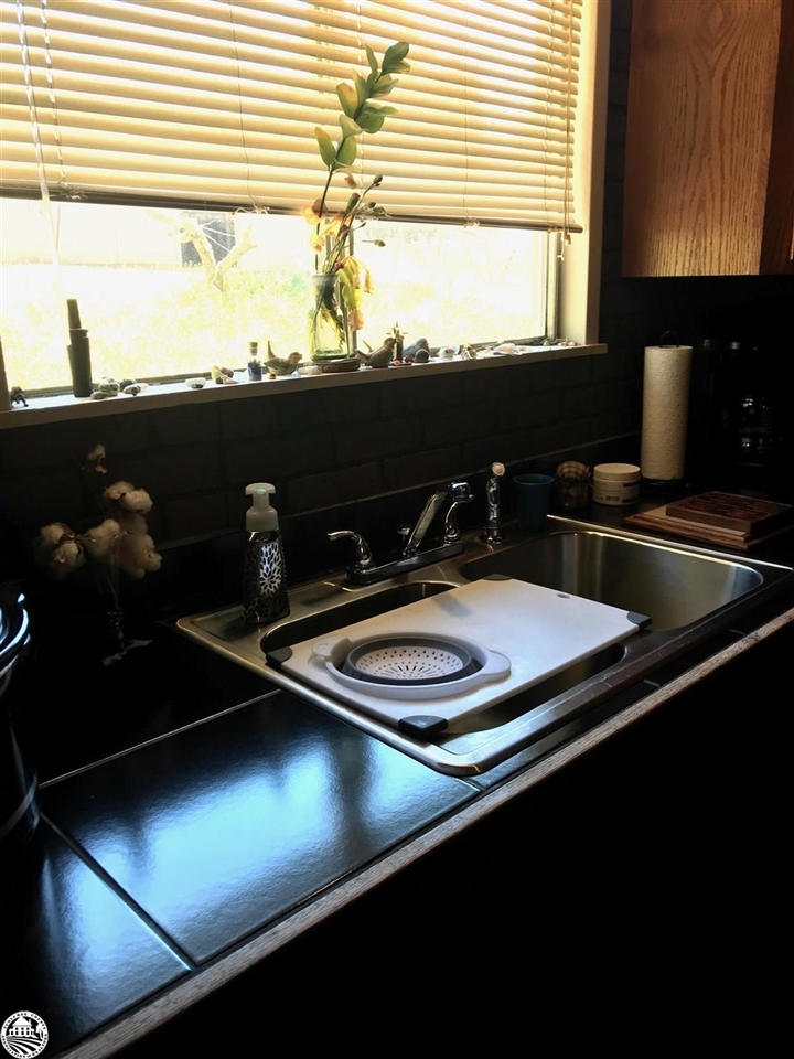 18191 Woodham Carne Road Sonora, CA 95370 - Photo 22 of 47 a close view of sink a stove and a microwave oven