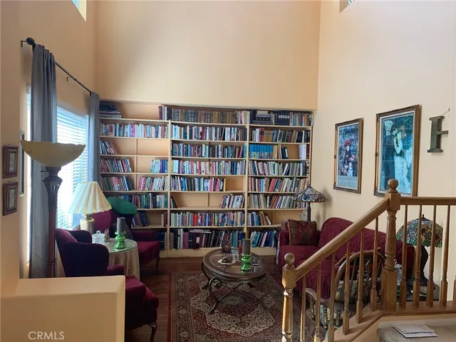 a living room with furniture and a book shelf