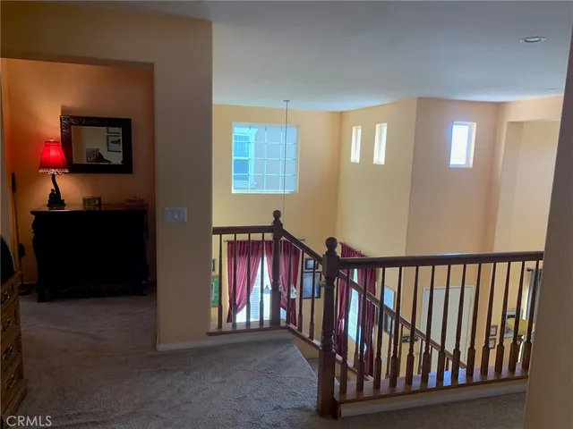 a view of a hallway with windows and entryway