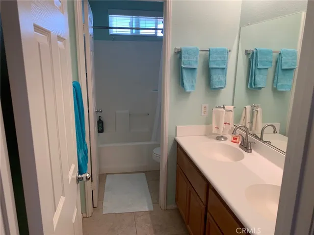 a bathroom with a sink vanity tub and shower