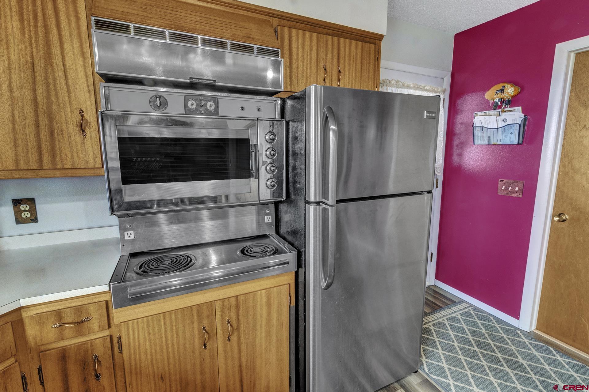 22755 Uintah Road Cedaredge, CO 81413 - Photo 12 of 35 a kitchen with stainless steel appliances granite countertop a stove a refrigerator and a microwave