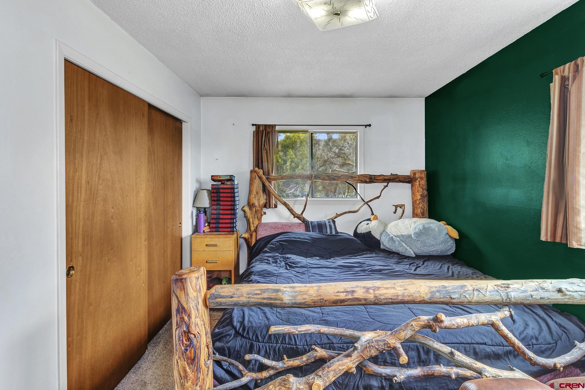 22755 Uintah Road Cedaredge, CO 81413 - Photo 17 of 35 a living room with furniture and a wooden floor