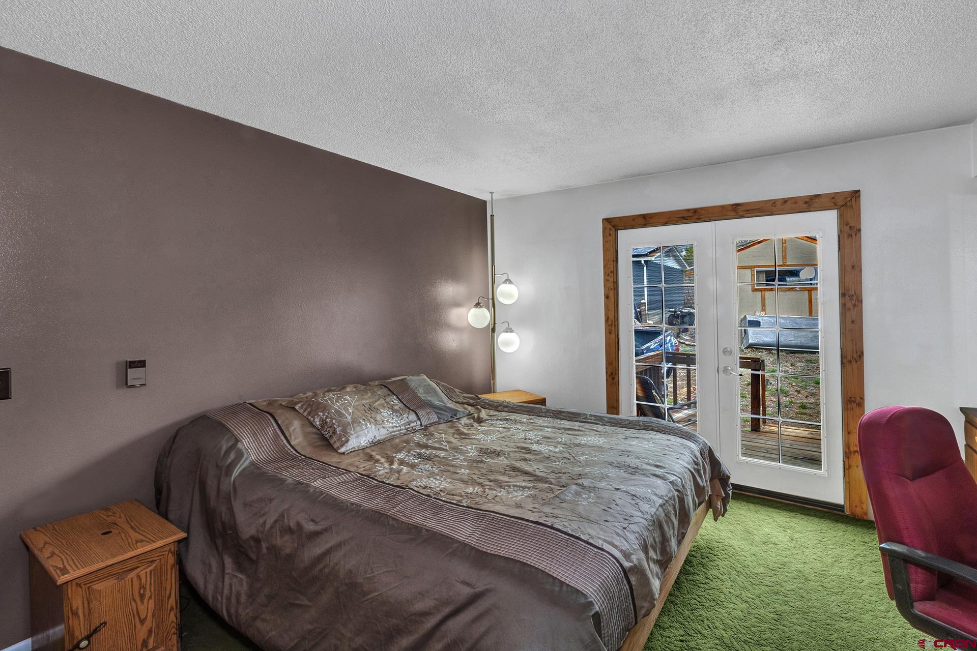 22755 Uintah Road Cedaredge, CO 81413 - Photo 21 of 35 a bedroom with a bed and a chair