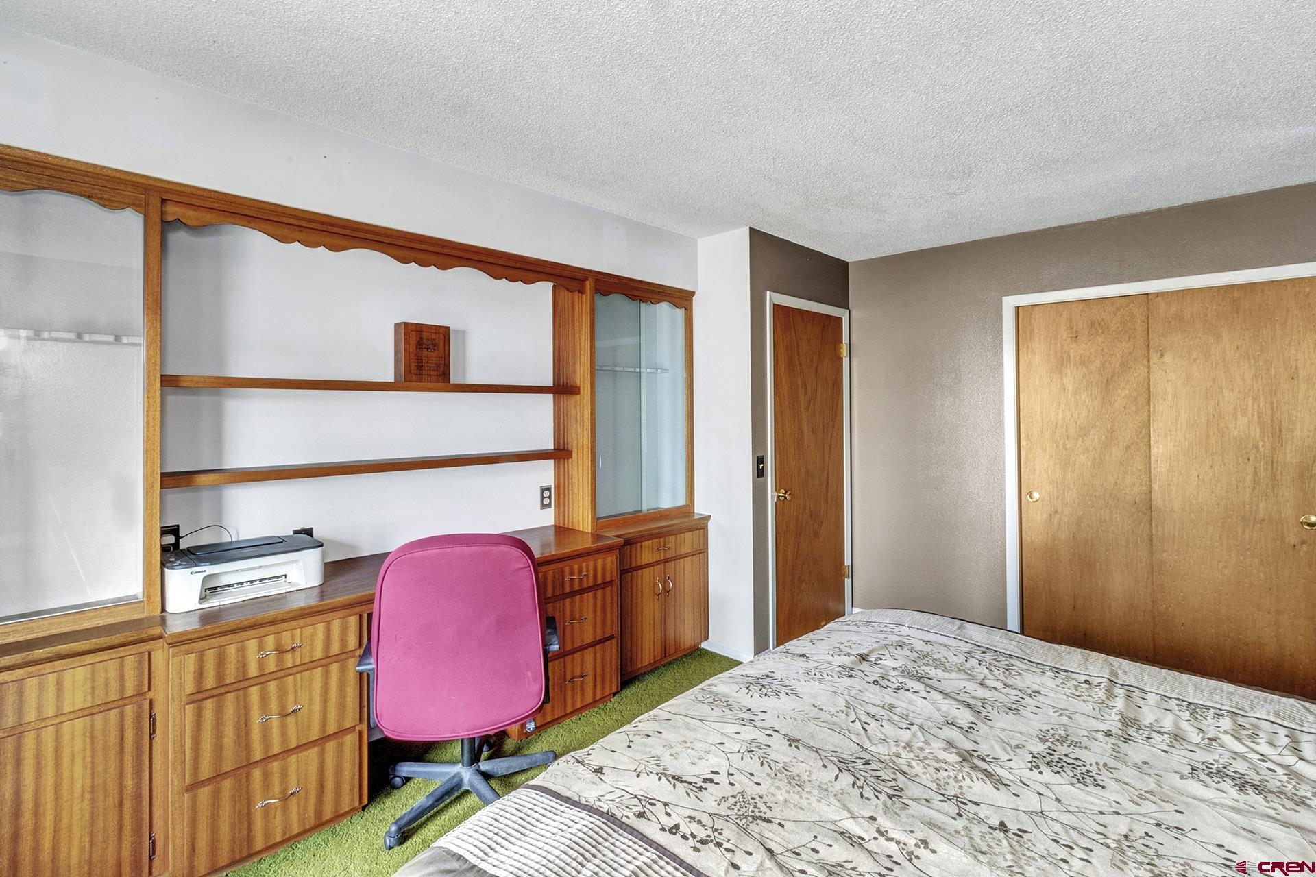 22755 Uintah Road Cedaredge, CO 81413 - Photo 22 of 35 a bedroom with a bed dresser and a window