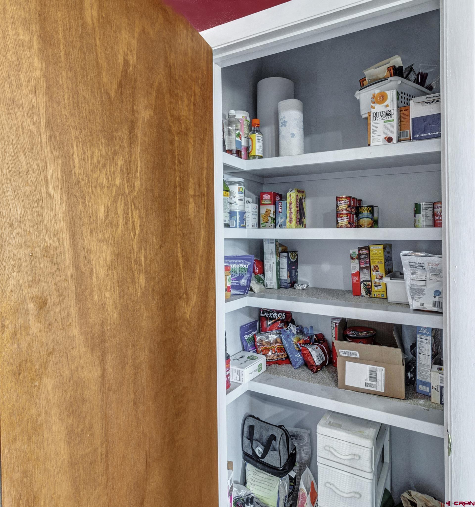 22755 Uintah Road Cedaredge, CO 81413 - Photo 23 of 35 a shelf with cup and plates