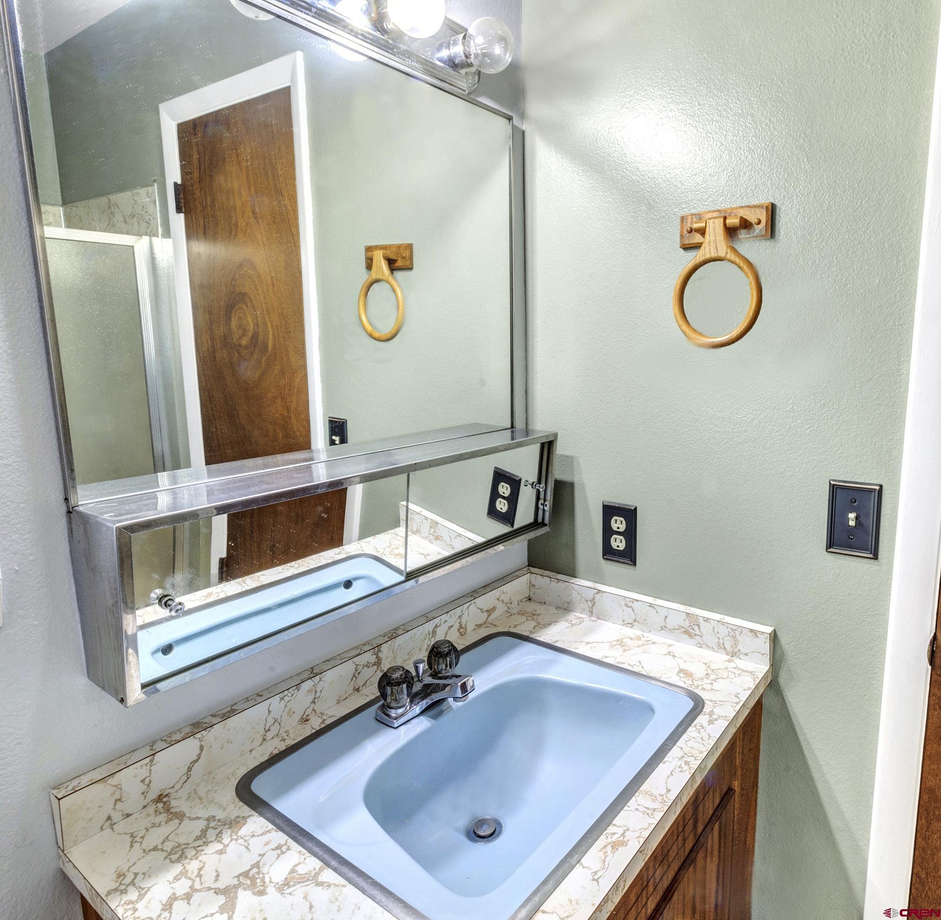 22755 Uintah Road Cedaredge, CO 81413 - Photo 27 of 35 a bathroom with a sink vanity and mirror