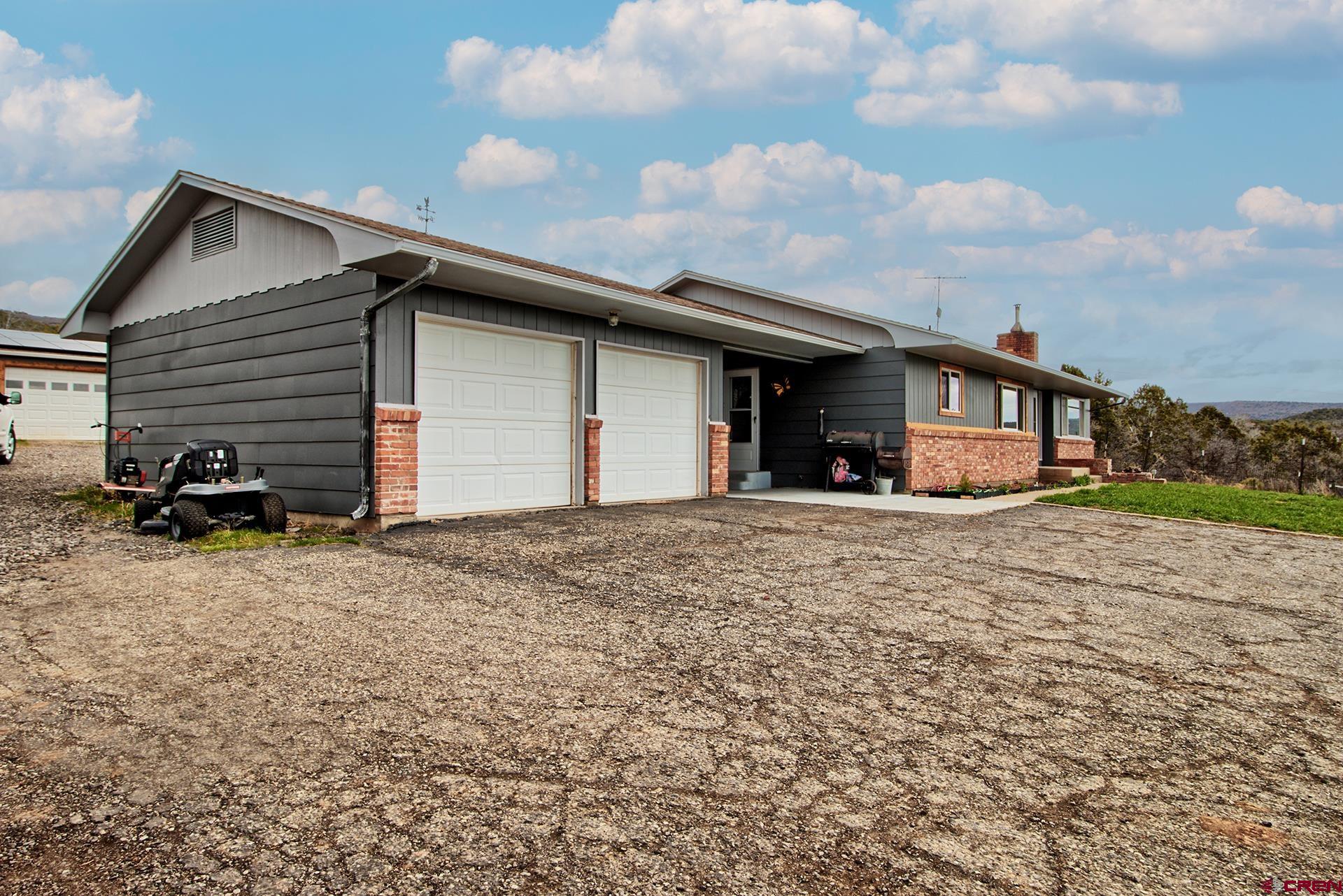 22755 Uintah Road Cedaredge, CO 81413 - Photo 31 of 35 a front view of a house with a yard