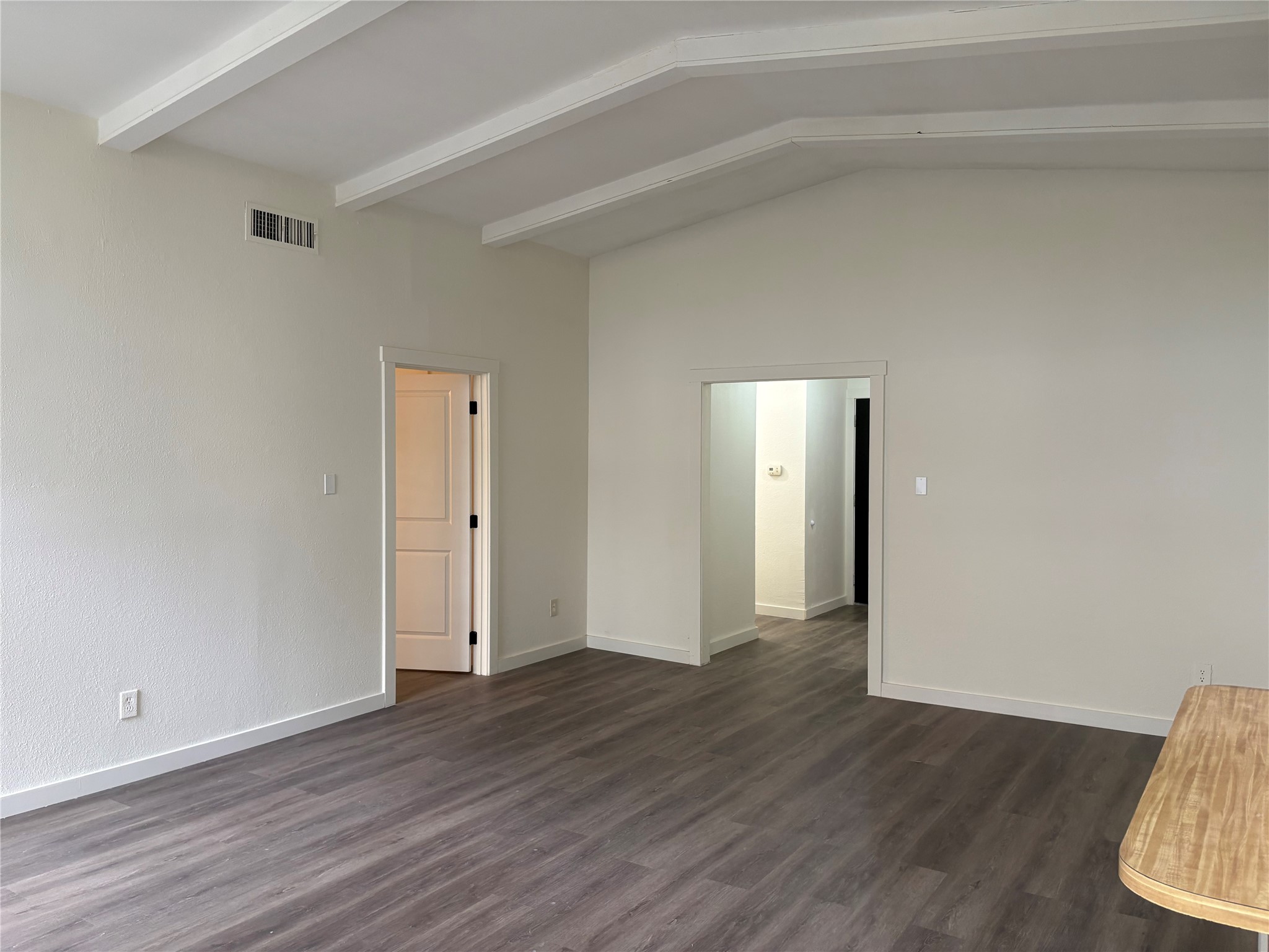 11913 Rennalee Loop Austin, TX 78753 - Photo 8 of 40 A living area features vaulted ceilings and resilient flooring, creating a spacious and low-maintenance environment.