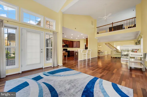 a living room with furniture and a table with wooden floor