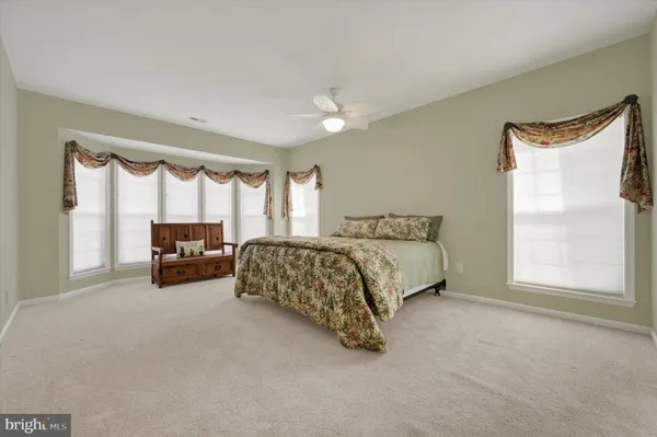 a spacious bedroom with a bed and a couch