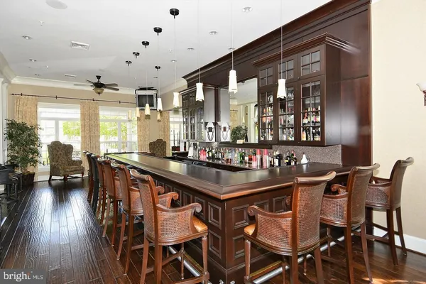 a kitchen with stainless steel appliances granite countertop table chairs and wooden floor