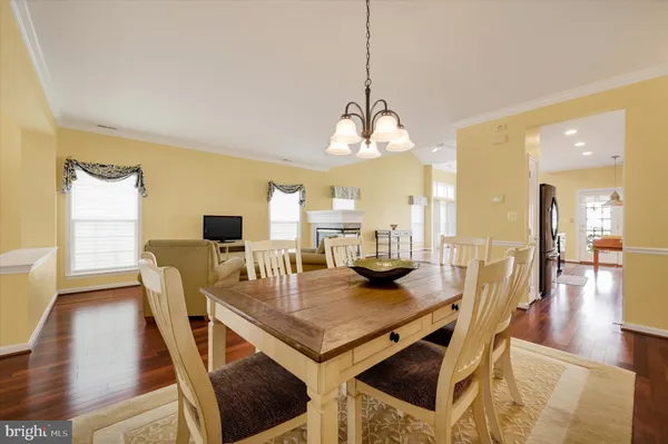 a view of a dining room with furniture wooden floor and chandelier