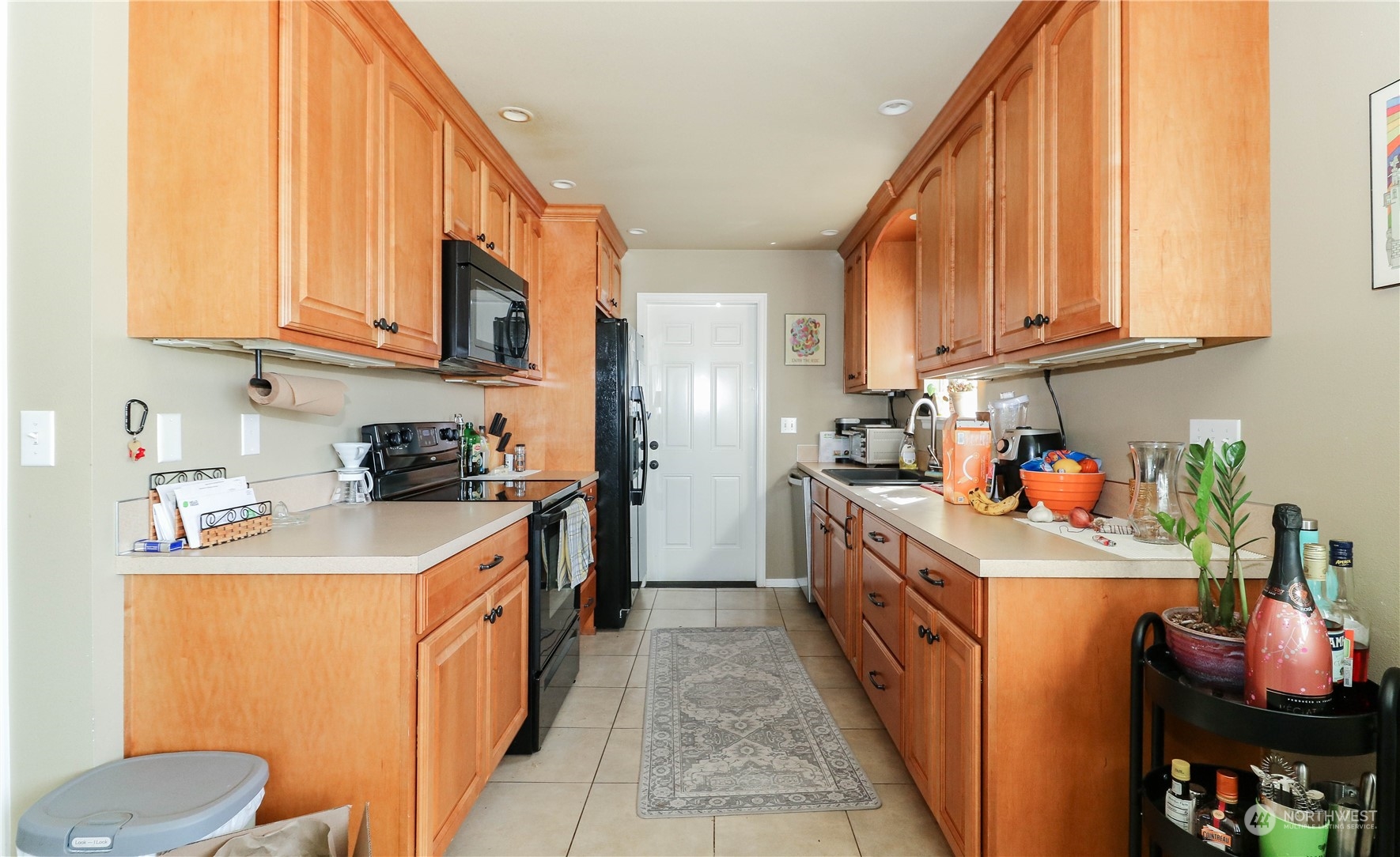 405 Northwest Market Street Seattle, WA 98107 - Photo 11 of 33 a kitchen with stainless steel appliances granite countertop a sink stove and cabinets