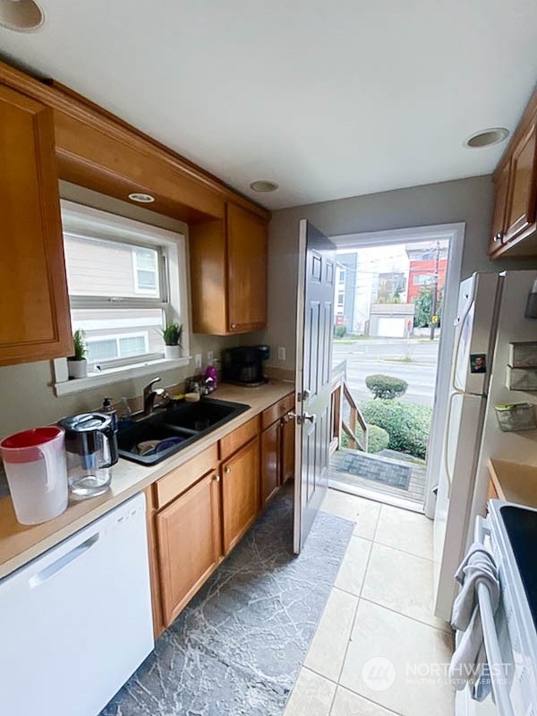 405 Northwest Market Street Seattle, WA 98107 - Photo 19 of 33 a kitchen with stainless steel appliances a stove a sink and a refrigerator