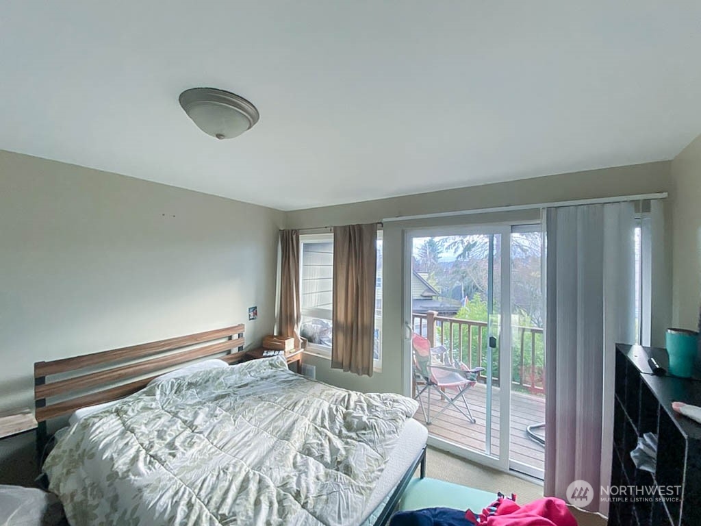 405 Northwest Market Street Seattle, WA 98107 - Photo 20 of 33 a bedroom with a bed and large windows