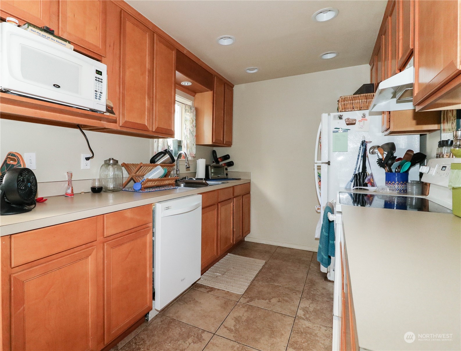 405 Northwest Market Street Seattle, WA 98107 - Photo 27 of 33 a kitchen with sink cabinets and window