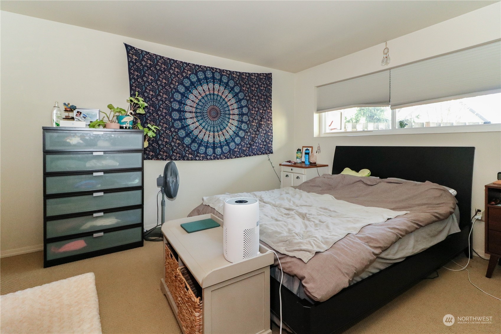 405 Northwest Market Street Seattle, WA 98107 - Photo 28 of 33 a bed sitting in a bedroom next to a window with a flat screen tv