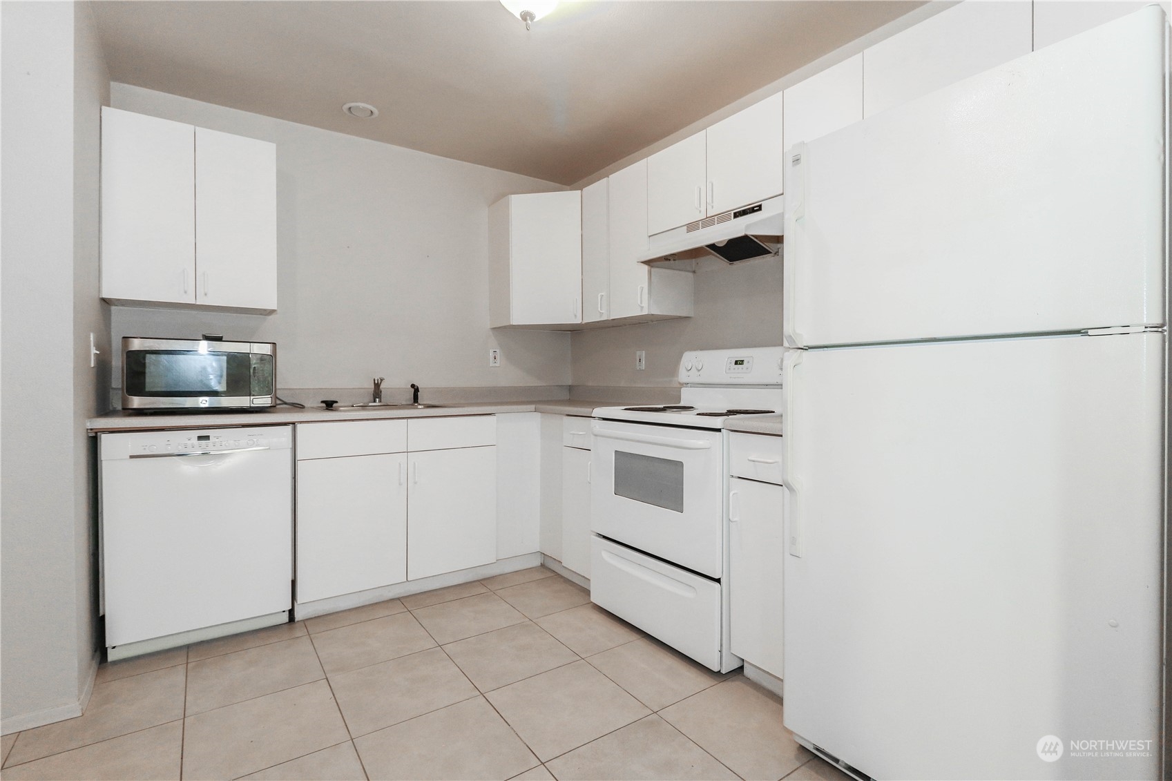 405 Northwest Market Street Seattle, WA 98107 - Photo 4 of 33 a kitchen with white cabinets and white appliances