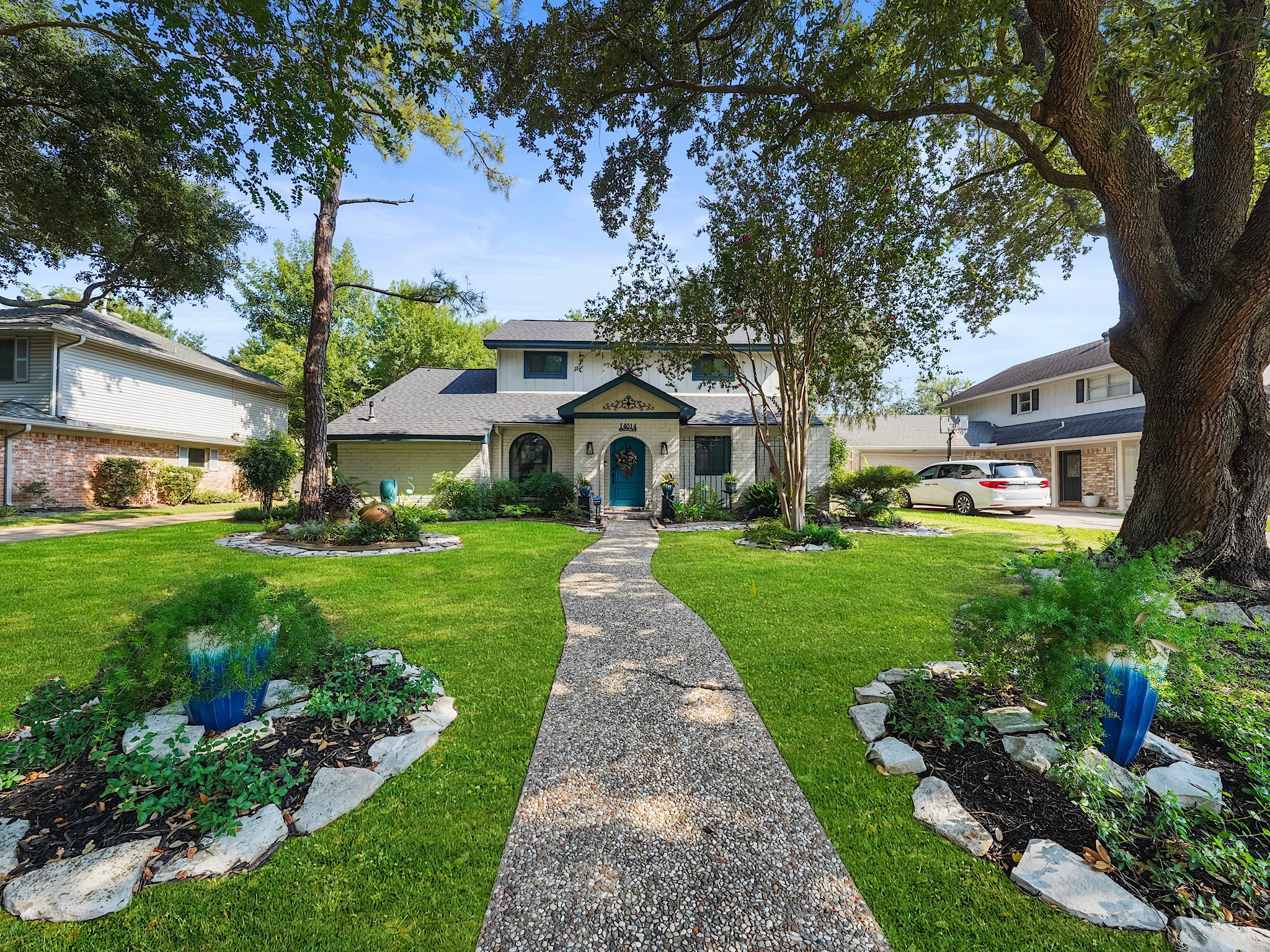 14014 Locke Lane Houston, TX 77077 - Photo 2 of 35 a front view of a house with a yard and potted plants