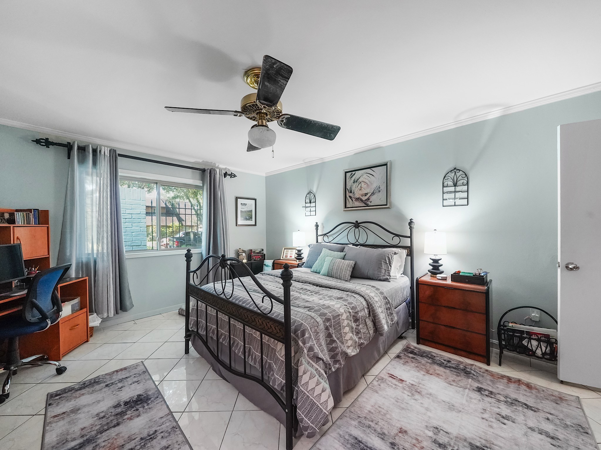 14014 Locke Lane Houston, TX 77077 - Photo 24 of 35 a bedroom with a bed a couch and a flat tv screen on the dresser