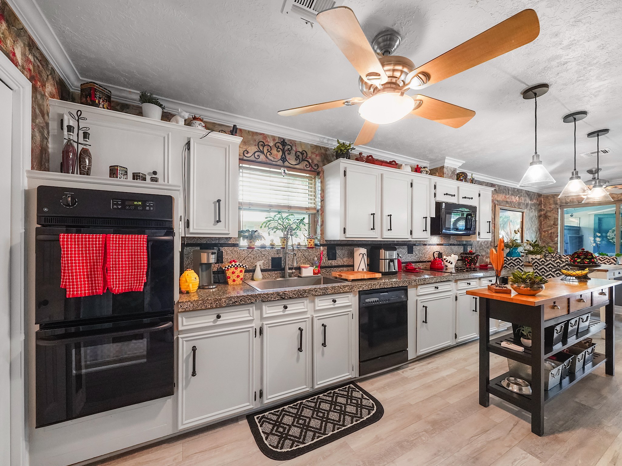 14014 Locke Lane Houston, TX 77077 - Photo 9 of 35 a kitchen with stainless steel appliances a stove a sink dishwasher and cabinets with wooden floor