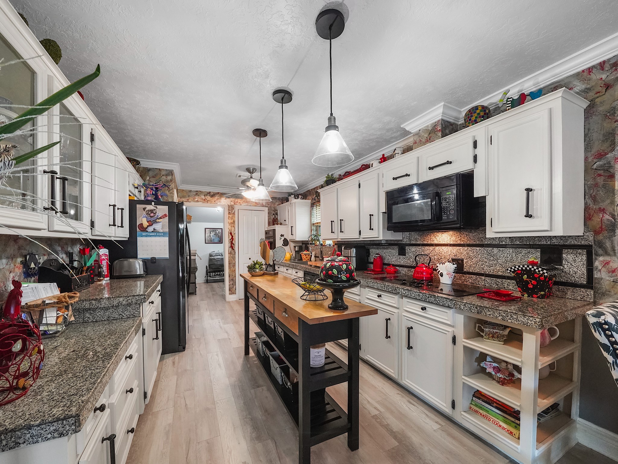 14014 Locke Lane Houston, TX 77077 - Photo 10 of 35 a kitchen that has a lot of cabinets a stove and a wooden floors