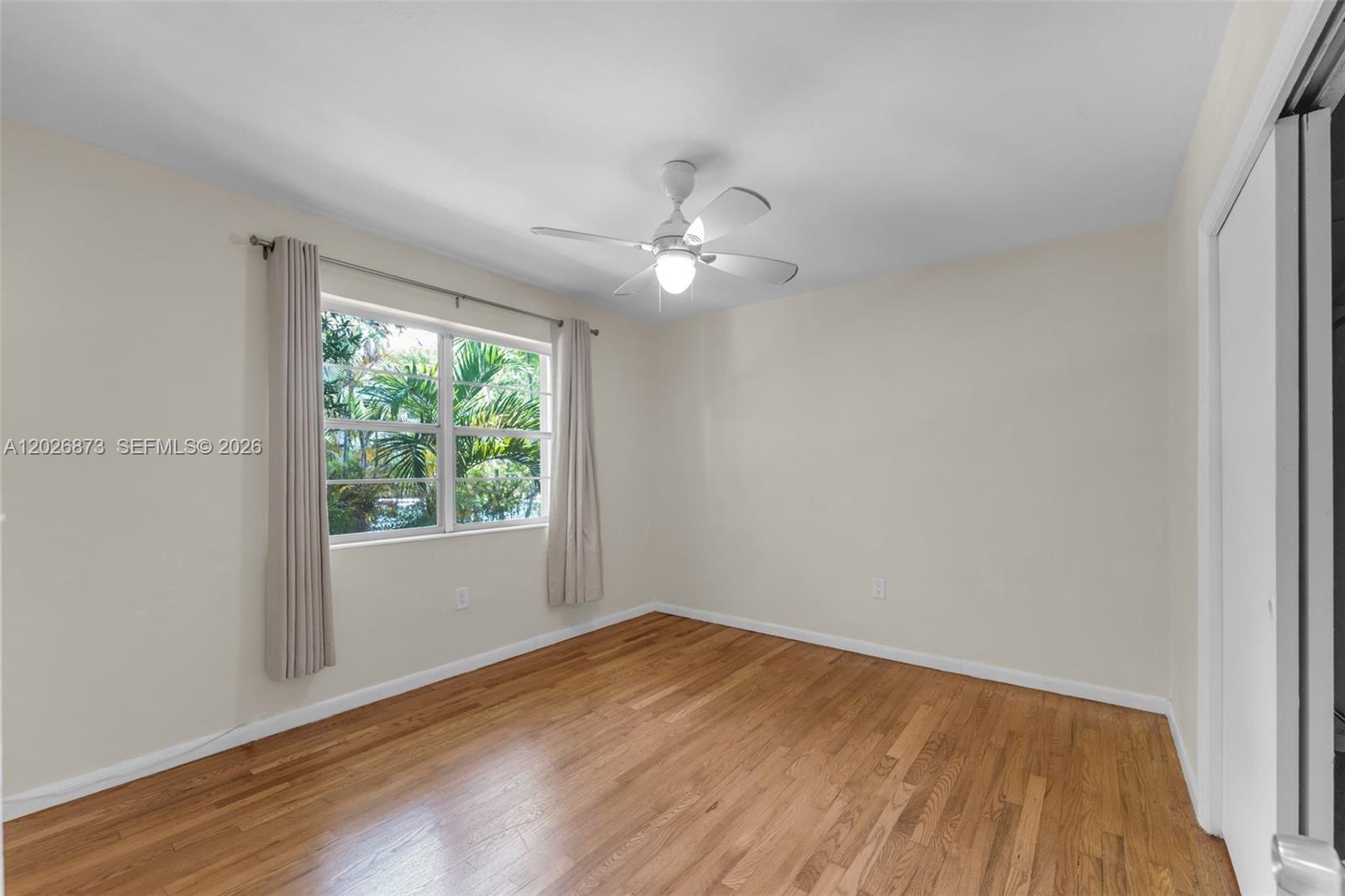 5590 Southwest 78th Street, Unit 133B Miami, FL 33143 - Photo 7 of 18 wooden floor in an empty room with a window