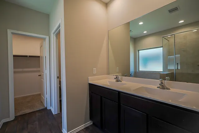 a bathroom with a double vanity sink and mirror