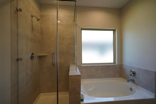 a bathroom with a bathtub and a shower