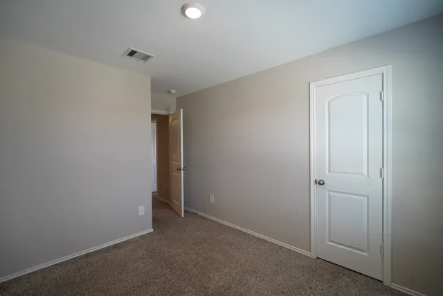 an empty room with closet area