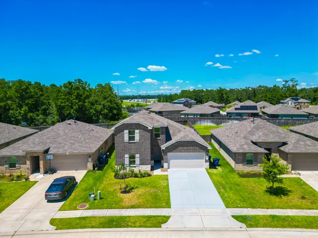 a aerial view of a house with swimming pool garden and patio