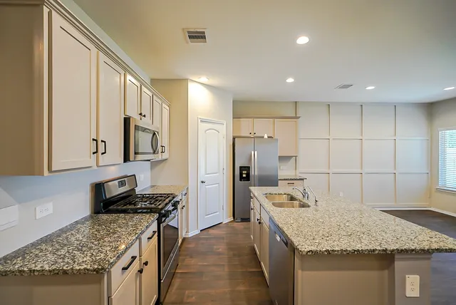 a kitchen with refrigerator and stove