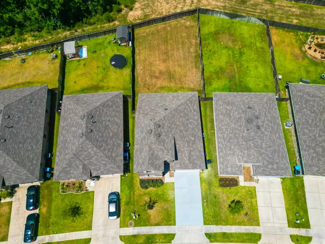 an aerial view of a house with a swimming pool