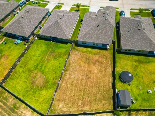 a view of swimming pool with a lawn chairs