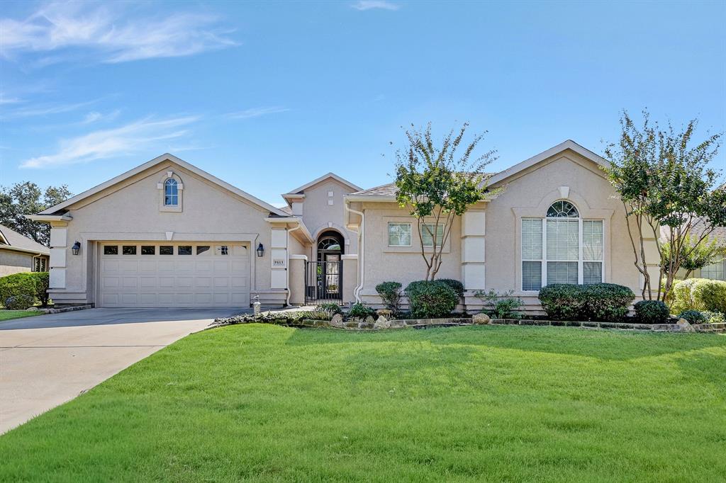 a front view of house with yard and green space