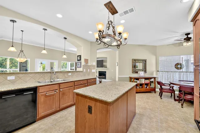 a large kitchen with a table and chairs in it