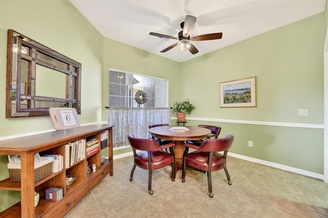 a view of a dining room with furniture and a chandelier