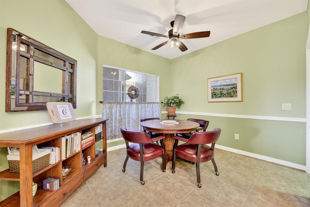 9813 Callaway Court Denton, TX 76207 - Photo 18 of 39 a view of a dining room with furniture and a chandelier