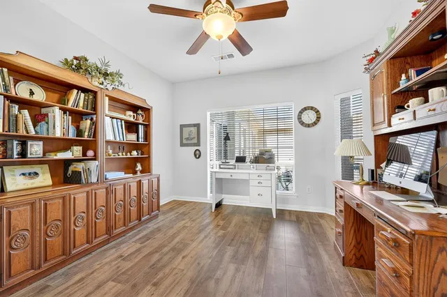 a open kitchen with stainless steel appliances a stove cabinets a rug and a book shelf